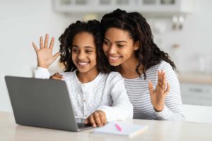 Cute black mother and kid having video call with teacher