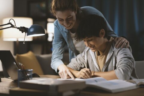 Tutor helping a student with his homework